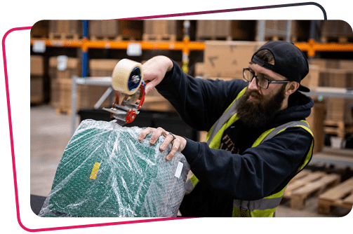 Man packaging industrial spare parts from EU Automation. powering UK manufacturing.